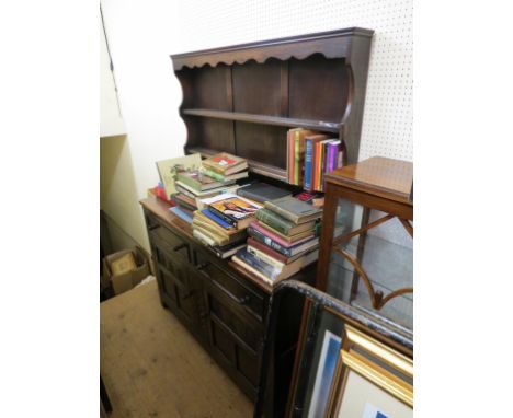 A solid, dark oak Welsh dresser, twin-shelf plate rack above carved and panelled base with two drawers, 4ft. 1in. 