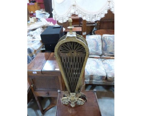 A brass 'peacock' folding firescreen