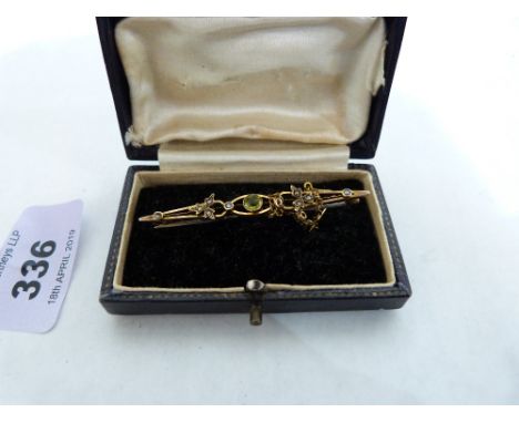 A gold peridot and split pearl bar brooch