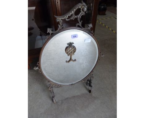 A brass rococo revival mirror firescreen. 34' high
