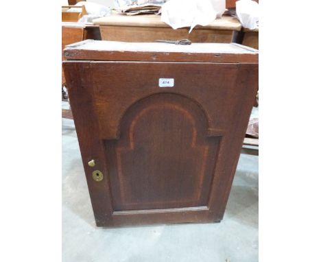 An 18th century oak hanging wall cupboard, the arch fielded and banded door enclosing shelves and two drawers. 21' wide