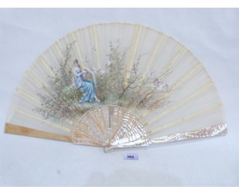 A French fan with mother-of-pearl and bone sticks, the silk leaf painted a lady in a garden. 25' span. Boxed