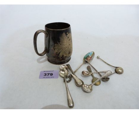 Three silver salt or mustard spoons, a continental enamel teaspoons, plated mug and six plated salt or mustard spoons