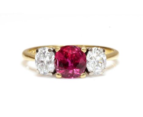 An 18ct gold three stone fracture filled ruby and diamond ring, by Kutchinsky, with an old circular mixed cut fracture filled