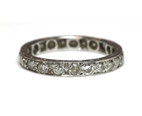 A diamond set full eternity ring,with a row of eight cut and Swiss cut diamonds, grain set to a flat section band with engrav