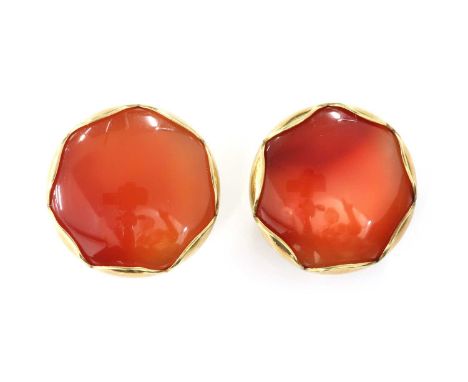 A pair of gold cornelian clip earrings,with a circular cabochon cornelian, set to scalloped mounts, with omega clip fittings.