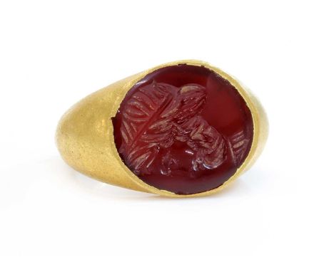 A Roman hollow gold hardstone intaglio ring,possibly 3rd century, with an oval flat hardstone tablet, intaglio engraved with 