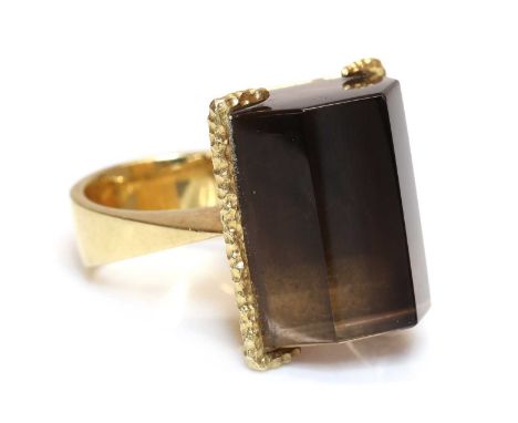 An 18ct gold single stone smoky quartz ring, by St John's College School of Art, c.1970,with a faceted smoky quartz crystal i