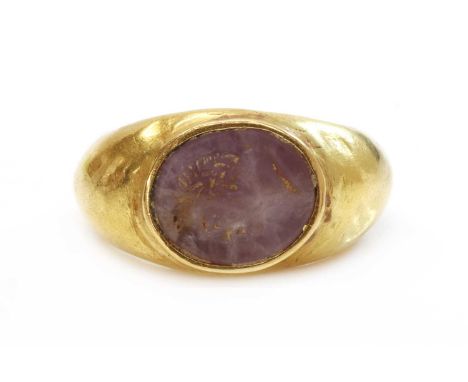 A Roman hollow gold hardstone intaglio ring,with a flat oval hardstone tablet, intaglio engraved with the head of a gentleman