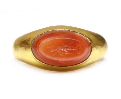 A Roman hollow gold hardstone intaglio ring,with an oval bevelled banded agate intaglio, engraved with a figure of Virtus Cou