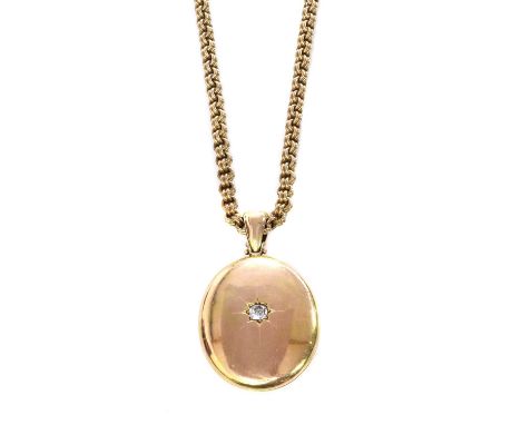 A Victorian gold diamond set locket and chain,the oval locket star set to the centre with old mine cut diamond, to an articul