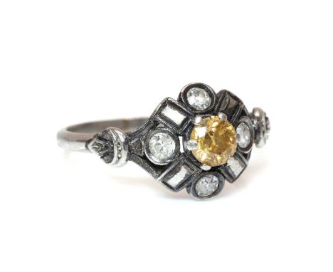 A diamond cluster ring,with an old European cut diamond, possibly fancy orange/yellow, claw set to the centre. An old Swiss c