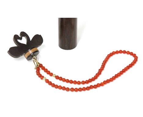 A 9ct gold cornelian bead necklace, by Clare Murray,in a presentation carved column case by Matthew Warwick. The uniform corn