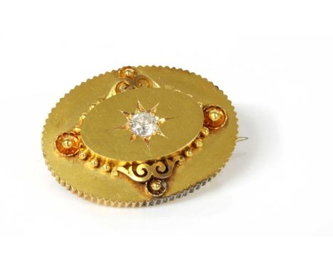 A Victorian gold diamond set oval shield form brooch, c.1870,with a raised central boss, with an old European cut diamond, st