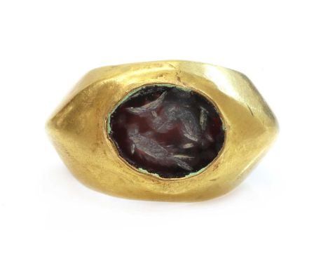 A Roman hollow gold hardstone intaglio ring,possibly 3rd century, with an oval hardstone tablet, intaglio engraved with a dol