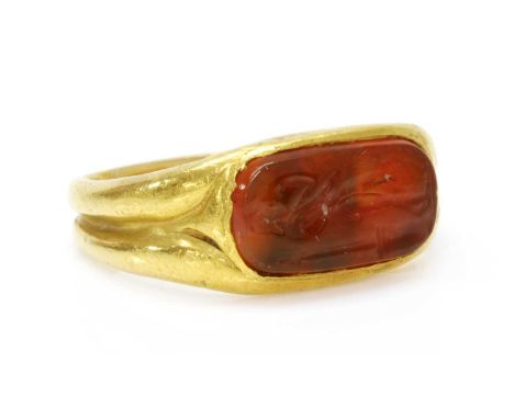 A high carat gold carved cornelian intaglio ring,possibly Roman 1st-3rd century, with a rectangular cushion cut cornelian int