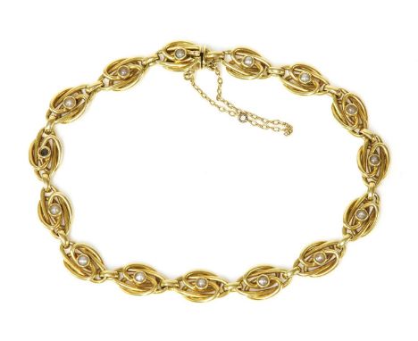 A Continental gold split pearl bracelet, c.1910,with a series of elongated knot links, each one with a split pearl rub set to