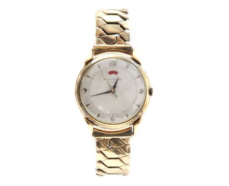 A gentlemen's Jaeger-LeCoultre mechanical strap watch,on a later expanding bracelet. A circular 34mm case, with a silvered di