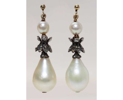 A pair of natural saltwater pearl and diamond drop earrings,on later screw fittings. Each drop or pommel shaped natural saltw