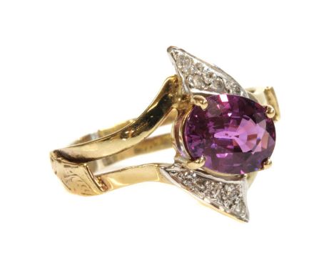 A gold single stone pink sapphire and diamond crossover ring, with an oval mixed cut pink sapphire believed to weigh 2.39ct, 