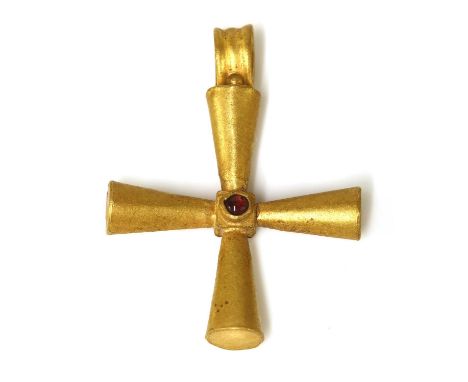 A Byzantine high carat gold garnet set hollow cross,with a cabochon garnet, rub set to the centre. Conical crossbars with a f