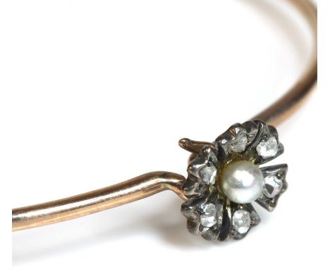 An Edwardian seed pearl and diamond flowerhead bangle,with a bouton shaped pearl peg set to the centre of the flower head, su