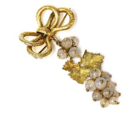 A Victorian gold grape and vine brooch,with hand engraved bow surmount. An articulated drop composed of textured and incised 