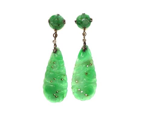 A pair of Art Deco carved jade and diamond drop earrings,with a circular carved and pierced jade plaque, double claw set at t