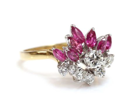 A diamond and ruby spray style cocktail cluster ring, c.1970,with a brilliant cut diamond, claw set to the centre. A staggere