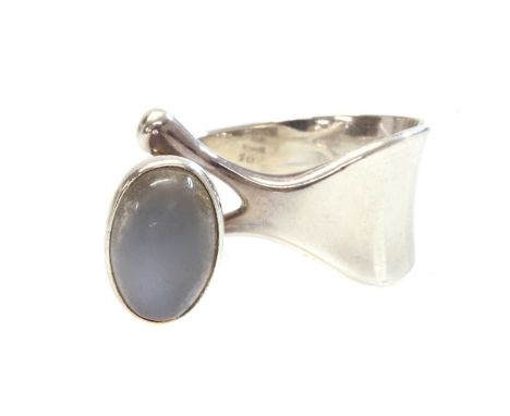 A sterling silver single stone moonstone ring, by Georg Jensen,no. 152, designed by Viviana Torun. With an oval cabochon moon