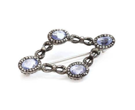 A sapphire and diamond lozenge shaped brooch, c.1900,with four sapphire and diamond cluster heads. Each oval mixed cut sapphi