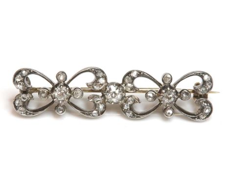 A Victorian diamond set bar brooch,with a pair of open bow shaped links, all grain set with graduated rose cut diamonds. Thre