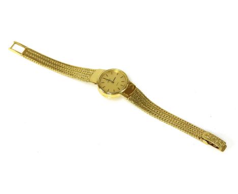 A ladies’ 18ct gold Omega quartz bracelet watch, with an oval landscape case, 22 x 20mm, with a champagne dial and baton hour