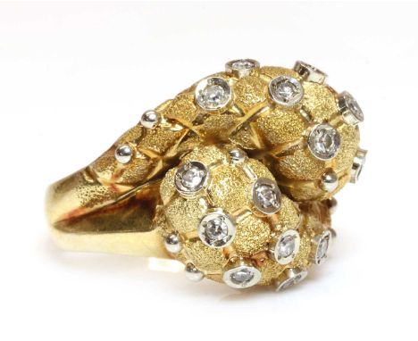 An 18ct two colour gold diamond set bombé form crossover ring,with an incised quilted finish. Scattered eight cut diamonds, s