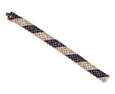 A four row diamond and sapphire bracelet, with four diagonal rows of graduated circular mixed cut sapphires, four claw set be