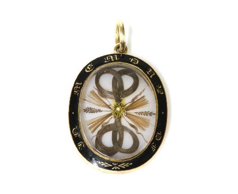 A Victorian gold glazed memorial locket,with sprays and coiled hair to a glazed cover, with black champlevé border 'in memory