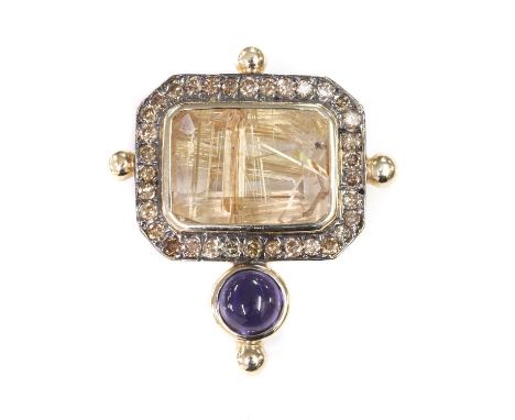 A gold rutilated quartz, iolite and diamond brooch,with an emerald cut rutilated quartz, rub set to the centre in a landscape