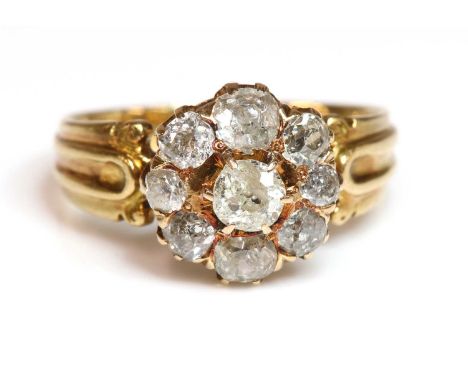 An Edwardian diamond cluster ring,with graduated old European cut diamonds, all claw set to a rex gallery, with a plain under