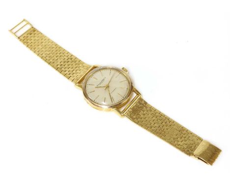 A gentlemen's 18ct gold International Watch Company automatic watch,on a later gold bracelet. A 34mm case with silvered dial,