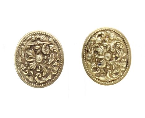 A pair of oval repoussé earrings,with raised scrolling flowers and buds, to later omega fittings. Tested as approximately 14c