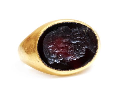 A Roman hollow gold hardstone intaglio ring,possibly 3rd century, with a flat hardstone tablet, intaglio engraved with the he