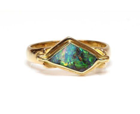 A gold Queensland boulder opal ring, by Mariusz Tomaszewski,with a freeform Queensland boulder opal, rub set to a stepped gal