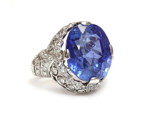 An Art Deco unheated sapphire and diamond ring,with an oval mixed cut sapphire, estimated as approximately 13.25ct, four claw