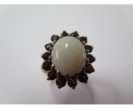 A hallmarked 9ct yellow gold opal and garnet ring, size O, approx 5.8 grams, head approx 17mm x 15mm, generally good 