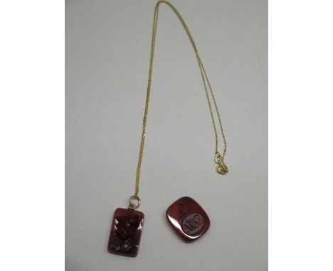 A well carved cornelian pendant, approx 22mm x 15mm, on an 18" long modern 18ct gold chain and also a cornelian intalgio seal