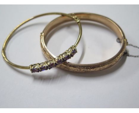 A 9ct amethyst hinged bangle, 6.5cm x 5.5cm external, in good condition and a hollow 9ct hinged bangle with wear and dents, a
