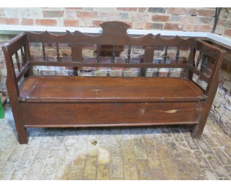 A 19th century Continental pine bench with a lift up seat with useful storage, 106cm tall x 181cm xx 49cm 