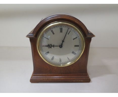 A small walnut mantle clock, 18cm tall, in working order 