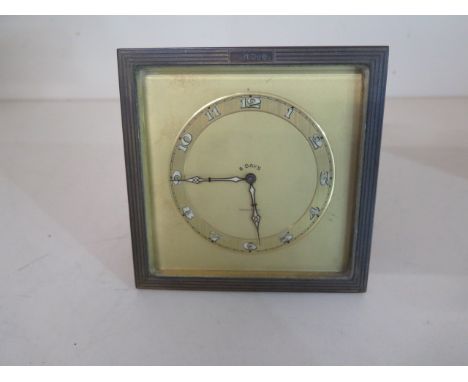 A Tiffany &amp; Co 8 day easel back desk clock, 12cm x 12cm, engraved C.M.Dub, hands advance, in working order, generally goo