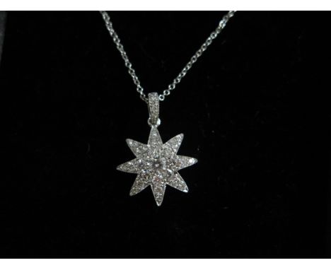 A white gold diamond encrusted star pendant and chain, approx 0.75ct, chain approx 18" long, pendant 2cm in length, good cond